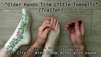 Older hands trim little toenails Older hands trim little toenails