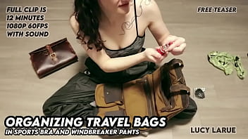 Organizing travel bags in sports bra and windbreaker pants Organizing travel bags in sports bra and windbreaker pants