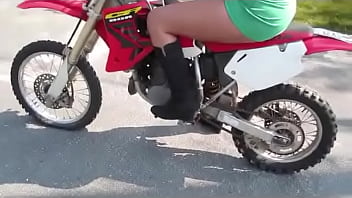 Girl revving a dirtbike Girl revving a dirtbike