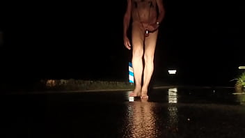 Naked hard exhib on the road on a rainy night of winter Naked hard exhib on the road on a rainy night of winter