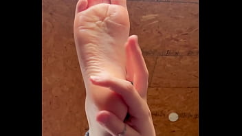 White girl takes socks off and puts lotion on her soft and clean feet White girl takes socks off and puts lotion on her soft and clean feet
