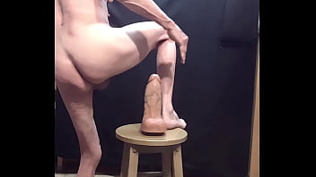 Busy-bottom naked on a big dildo