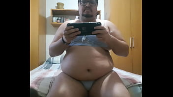 Chubby boy playing nintendo switch Chubby boy playing nintendo switch