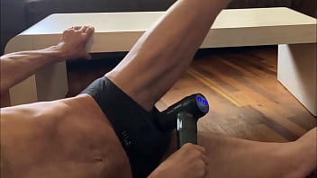 Preview of agressive myofascial pressure and release stretching on table in underwear with percussion massager