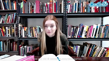 Redhead plays with her pussy on cam in library