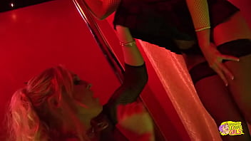 Two fair-haired exotic dancers with ample bosoms engage in a physical altercation but then reconcile via intimate contact