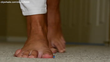 Giant girl crushing tiny man with cute bare foot