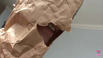 A woman with dark hair wearing stockings is engaged in sexual activity with a sex toy and two large erect penises