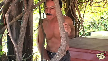 The mature gardener engages in vigorous anal intercourse with the attractive brunette beside the outdoor pool