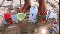 Foot fetish crushing water balloons with heels