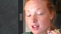 Following the act of engaging in sexual intercourse with two partners simultaneously, this individual with red hair receives a kind of sexual activity known as bukkake, in which several individuals ejaculate across her face