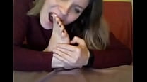 webcam model in sweatshirt suck her own toes