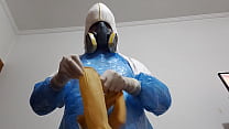 A cumshot on the glove, wearing a stinky jumpsuit and stinky rubber boots