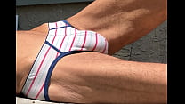 Stretching on Patio in Striped Briefs