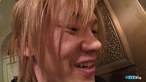 An Asian woman engages in a vigorous gangbang, culminating in an ejaculation over her face