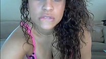 Curly hair blue eyed brunette plays with a big dildo