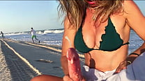 Busty milf skillfully jerks me off on the beach, not paying attention to passers-by