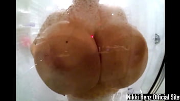 Seductive nikki benz soaps up her big tits during shower time