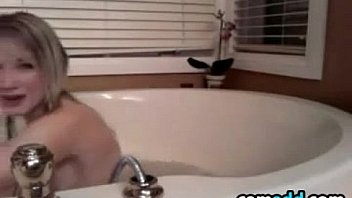 Pretty girl playing in the bath tub