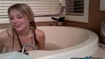 Pretty girl playing in the bath tub