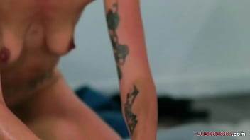 Inked babe and her boyfriend having oily fun on a mattress