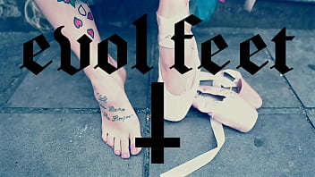 Ballerina wearing ballet shoes and walking down the street