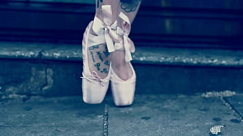 Ballerina wearing ballet shoes and walking down the street