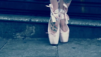 Ballerina wearing ballet shoes and walking down the street