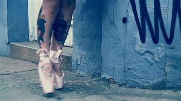 Ballerina wearing ballet shoes and walking down the street