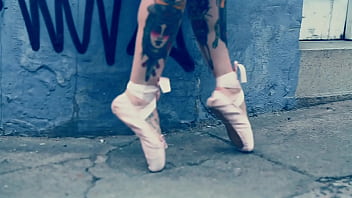 Ballerina wearing ballet shoes and walking down the street