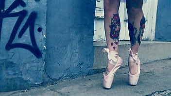 Ballerina wearing ballet shoes and walking down the street