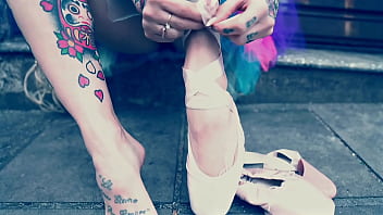 Ballerina wearing ballet shoes and walking down the street