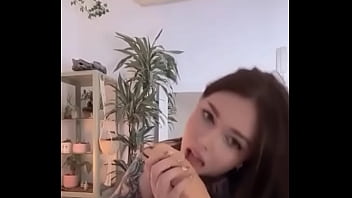 Tattooed girl sucks and jacks off dildo