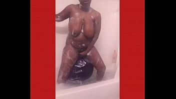 Purple dildo in a tub fill of bubbles