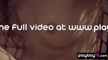 Cute brunette beauty posing naked at the tennis field