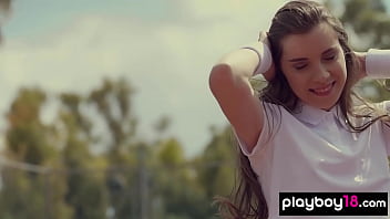 Cute brunette beauty posing naked at the tennis field