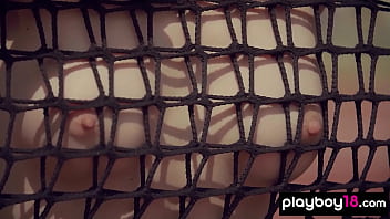 Cute brunette beauty posing naked at the tennis field