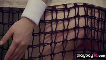 Cute brunette beauty posing naked at the tennis field