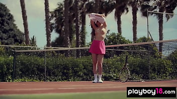 Cute brunette beauty posing naked at the tennis field