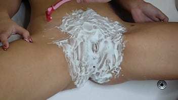 Shaving hairy pussy with trimmer and razor close up