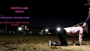 Man rides his pony without kneepads on the sand