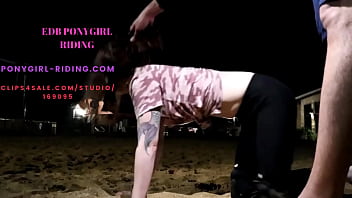 Man rides his pony without kneepads on the sand