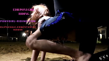 Man rides his pony without kneepads on the sand