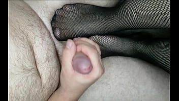 Baby jerks off a big cock with her legs in stockings