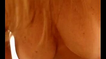 Busty shows her tits in her house