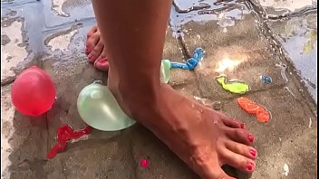 Foot fetish crushing water balloons with heels