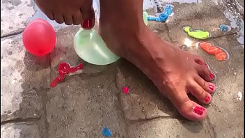 Foot fetish crushing water balloons with heels