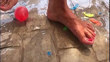 Foot fetish crushing water balloons with heels