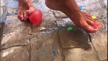 Foot fetish crushing water balloons with heels