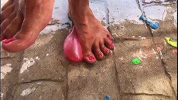 Foot fetish crushing water balloons with heels
